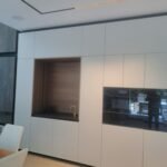 elegant European-style white kitchen cabinets installed in a modern kitchen